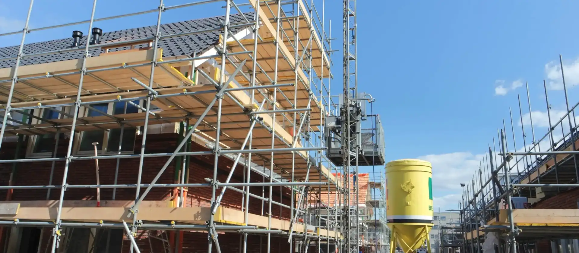 Scaffolding around new houses under construction on a housing development