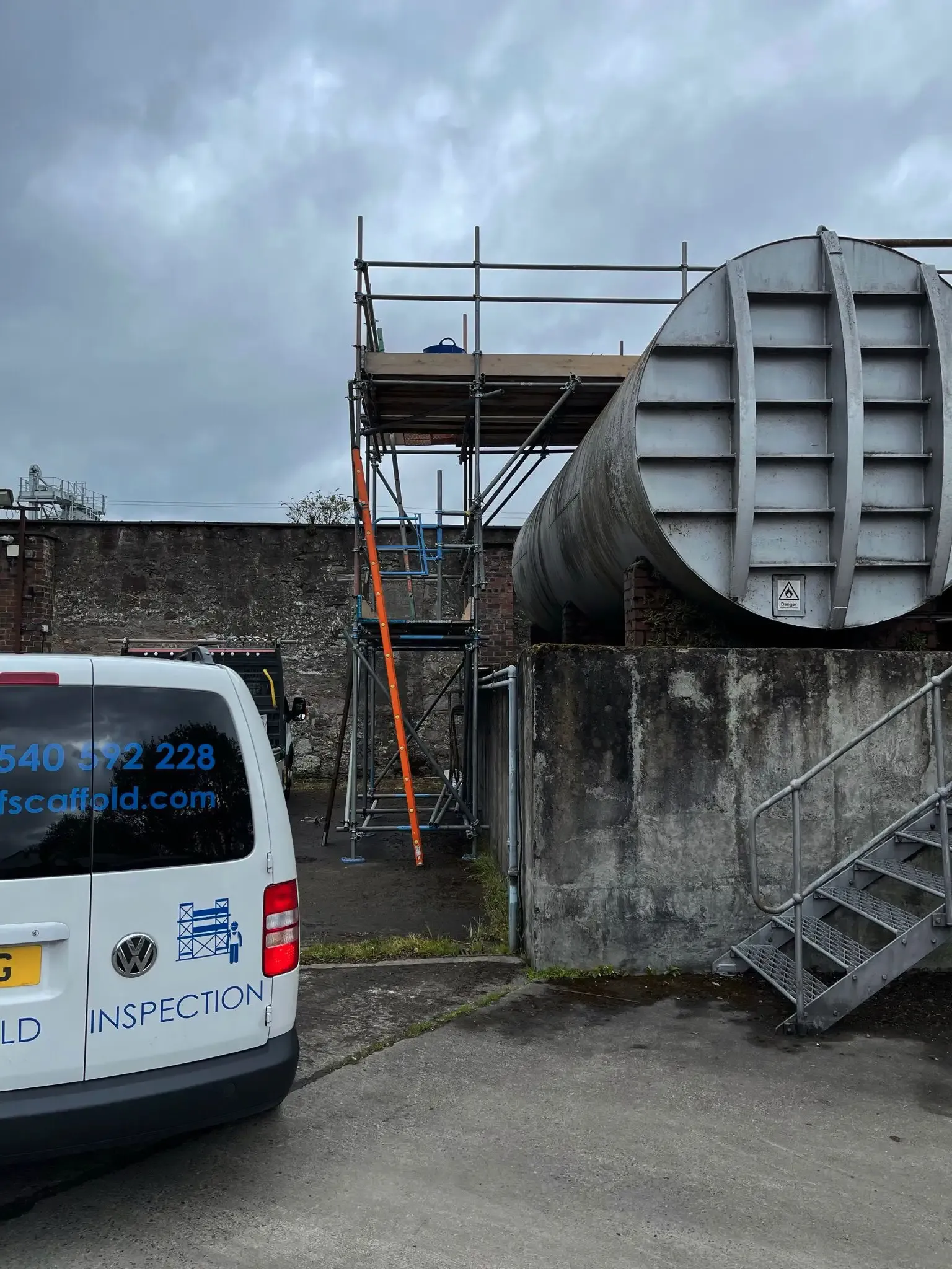Scaffold access to the top of a large industrial tank, with an M.F Scaffold van alongside