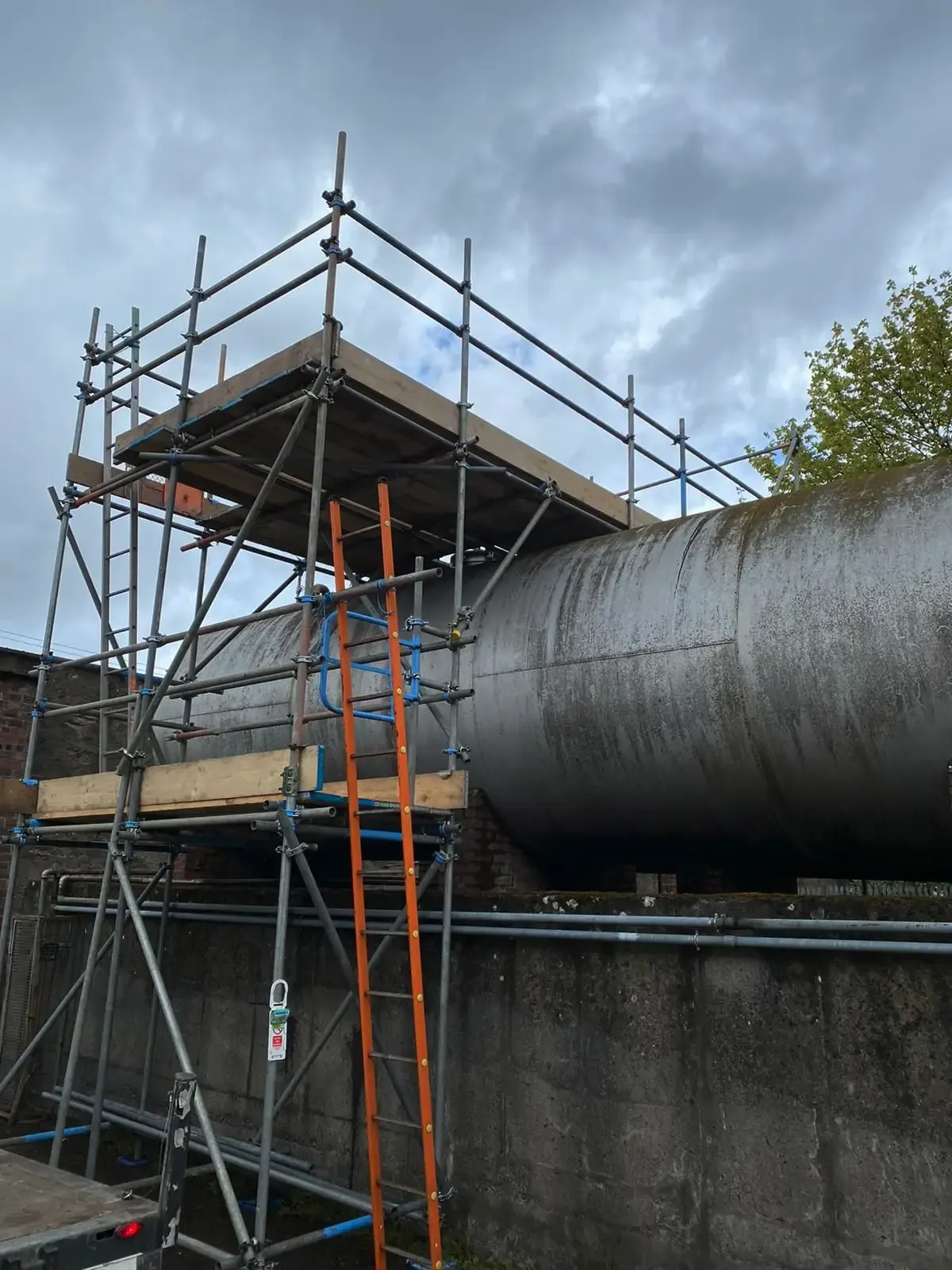 Scaffolding built around a large industrial storage tank