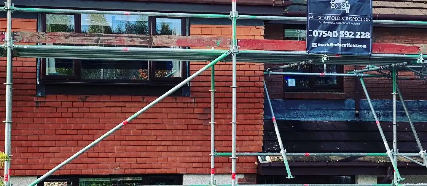 Domestic scaffolding around a house with an M.F Scaffold site banner