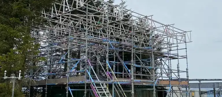 Scaffolding and safety mesh around all sides of a large building
