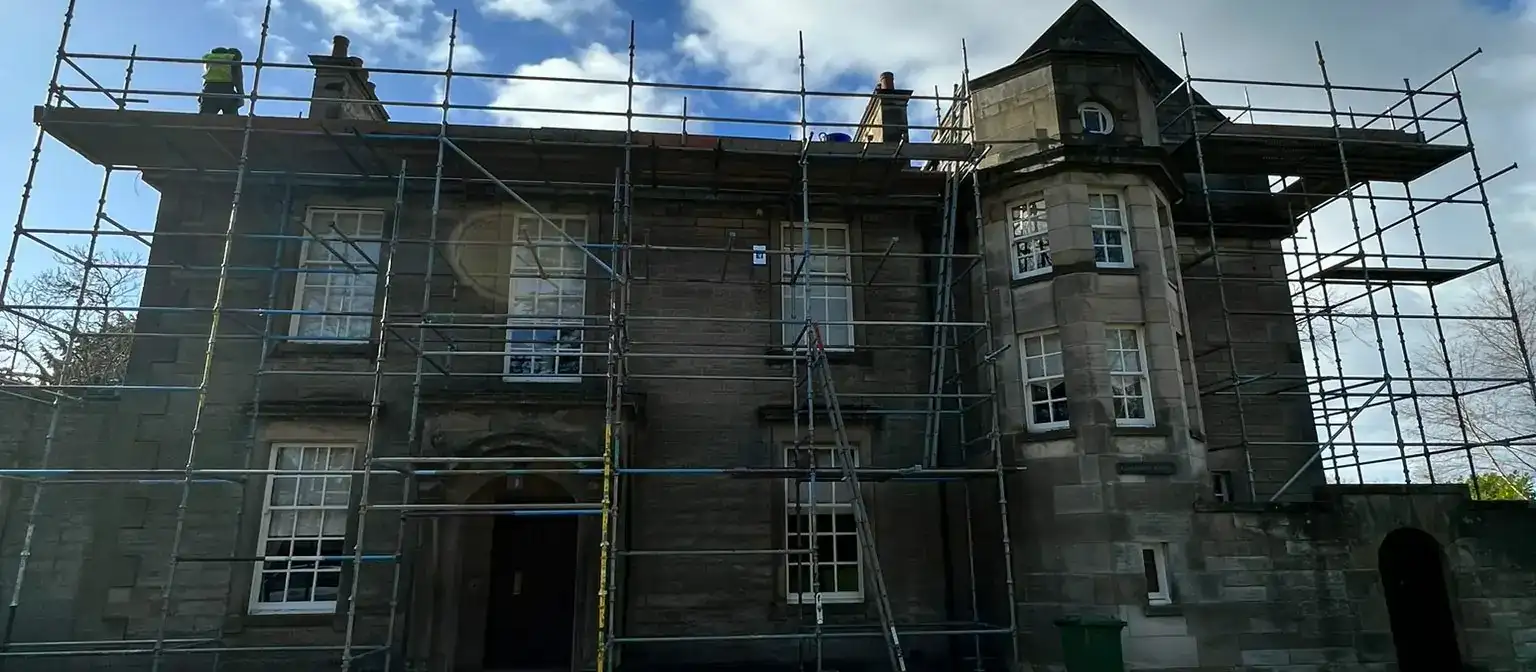Full scaffold around a traditional stone house