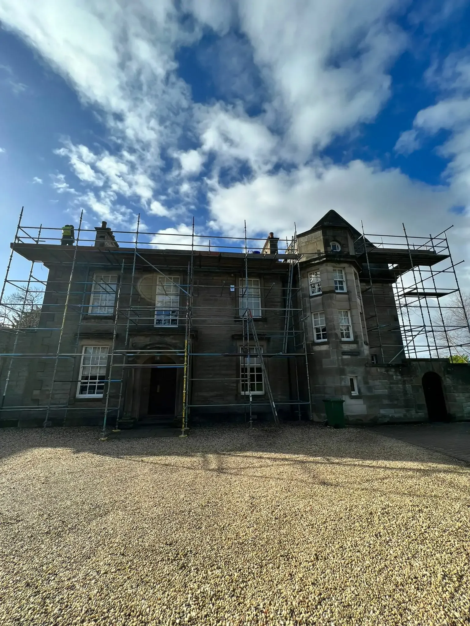 Full scaffold around a traditional stone house