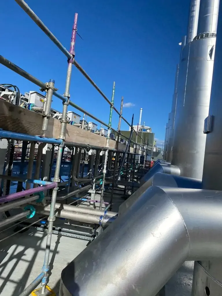 Industrial scaffolding alongside large steel pipework