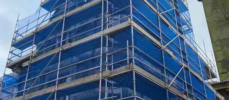 Multi-storey scaffold wrapped in blue sheeting
