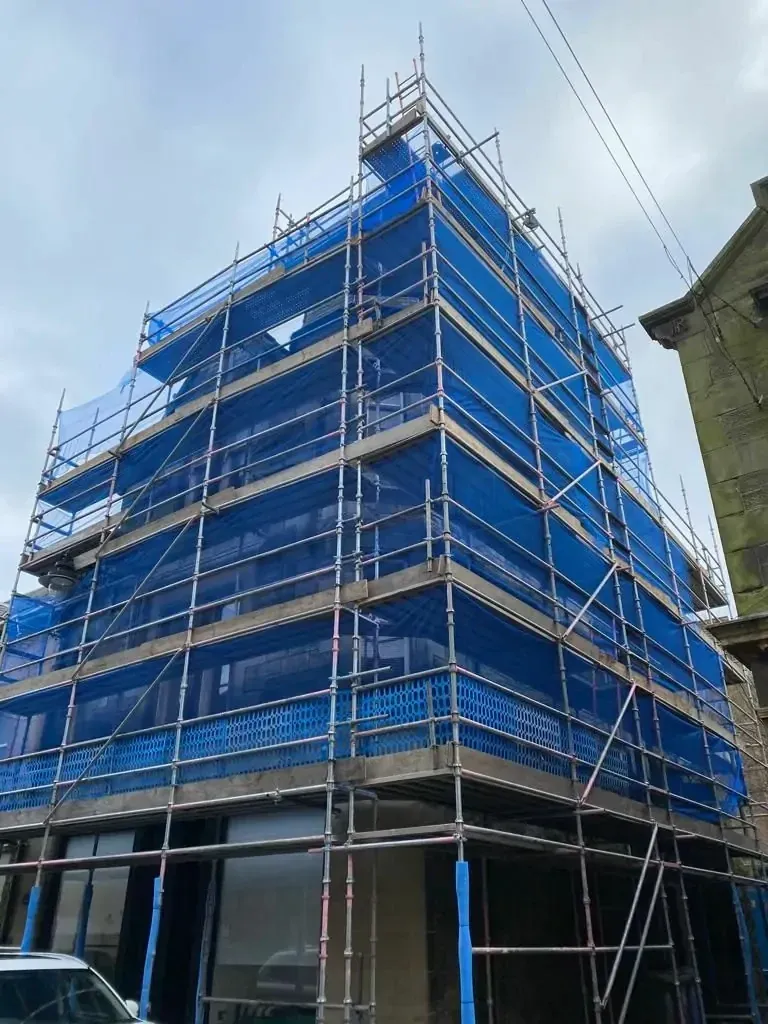 Multi-storey scaffold wrapped in blue sheeting