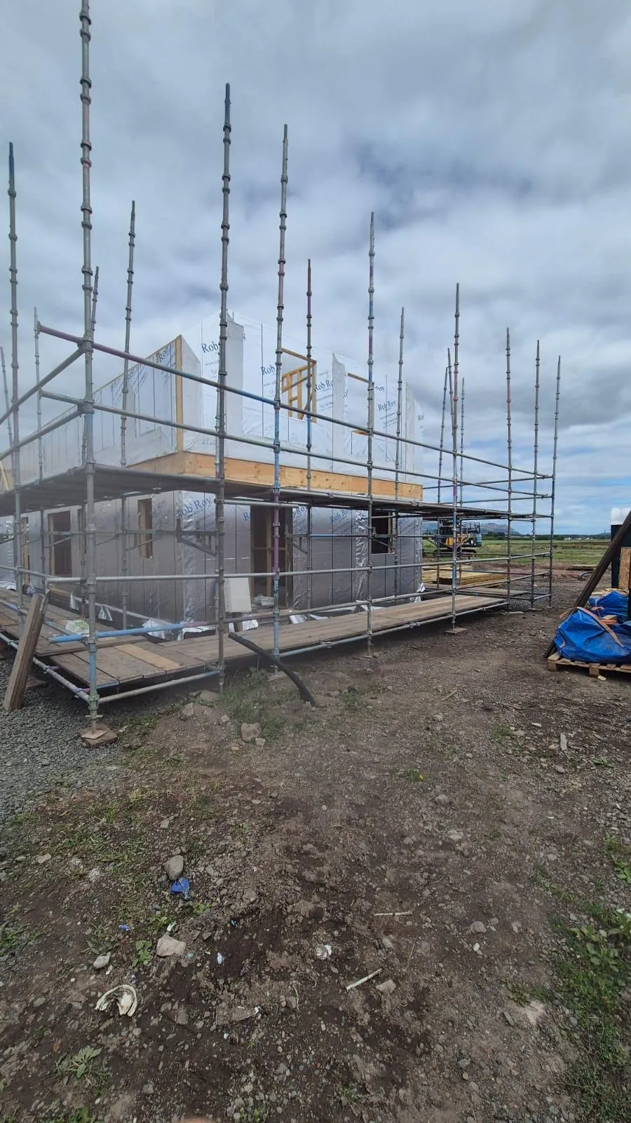 Scaffolding around a timber-frame house under construction